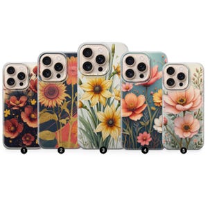 May include: Five phone cases with floral designs. The cases feature various flowers, including sunflowers and poppies, in shades of yellow, orange, and pink. The backgrounds vary from dark blue to light blue and white.