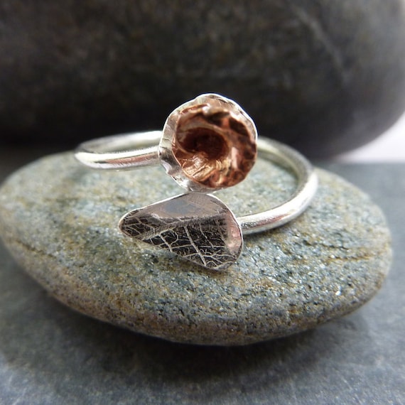 Adjustable silver ring with sterling silver textured leaf and copper rose flower: Handmade sterling silver.  One size fits all ring