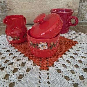 May include: A set of three ceramic mugs with a speckled, matte finish. The mugs are in shades of cream, light gray, and dark gray. Each mug has a simple, minimalist design, perfect for coffee or tea.