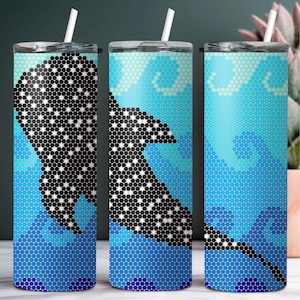 May include: A stainless steel tumbler with a blue and white mosaic pattern featuring a black and white manta ray. The tumbler has a straw and a lid.