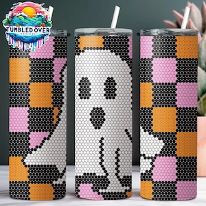May include: Three cylindrical tumblers with white lids and straws, featuring a repeating pattern of black, orange, and pink squares. The center tumbler displays a large white ghost figure composed of small dots, while the others show partial ghost shapes.
