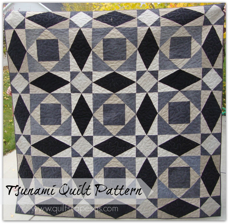 May include: A quilt pattern featuring a geometric design with black, gray, and beige squares and diamonds. The quilt is titled "Tsunami Quilt Pattern" and includes the website "www.quiltscapesas.com".