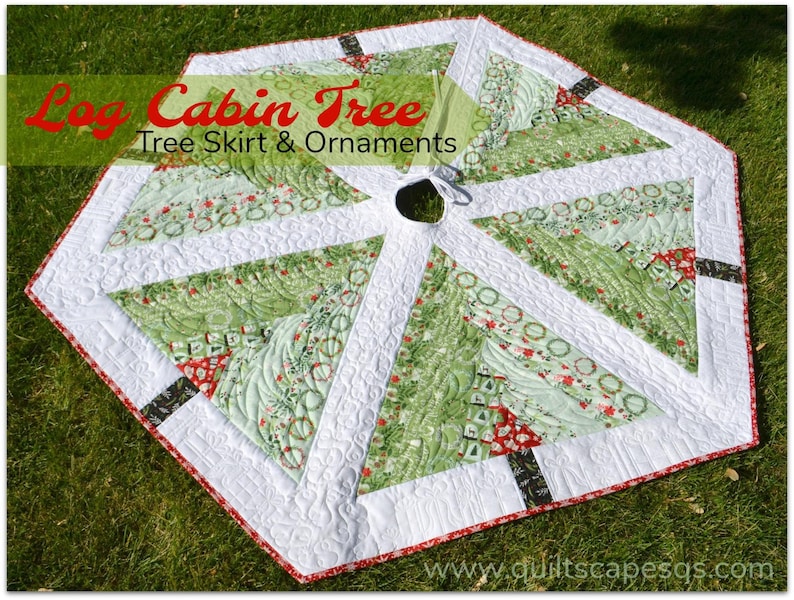 May include: A green and white quilted Christmas tree skirt with a red and black trim. The skirt is shaped like a hexagon and has a hole in the center for a tree stand. The skirt is decorated with a variety of Christmas-themed patterns, including wreaths, trees, and snowflakes. The text "Log Cabin Tree Tree Skirt & Ornaments" is printed on the skirt. The website "www.quiltscapesqs.com" is printed on the bottom of the skirt.