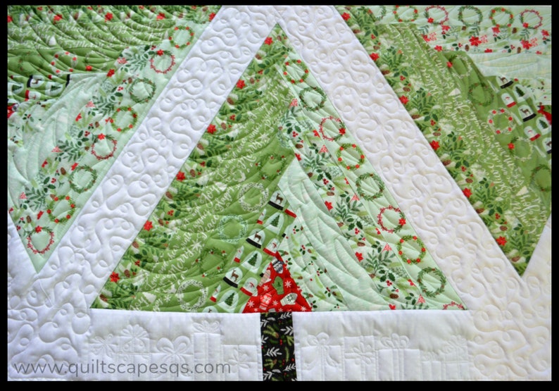 May include: A green and white Christmas quilt with a quilted tree design. The tree is made of different fabrics with a variety of Christmas patterns, including wreaths, holly, and snowflakes. The quilt is quilted with a swirling pattern.