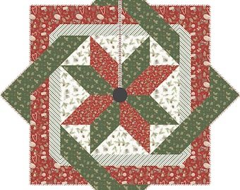 May include: A Christmas tree skirt with a starburst design. The skirt features a central star pattern in red and green, surrounded by alternating sections of patterned fabric and striped borders. The overall design is festive and holiday-themed.