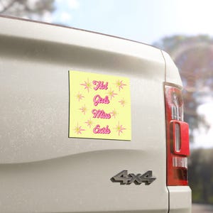 Può includere: Un adesivo quadrato con sfondo giallo pallido che presenta il testo rosa Hot Girls Miss Exits in un carattere retrò. Il design è decorato con molteplici forme di stelle rosa sparse attorno alla scritta, creando un display visivo vibrante e accattivante su una superficie chiara.