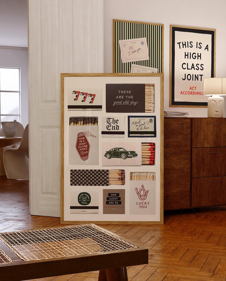 May include: A rectangular framed wall art print featuring a collage of various matchbox designs. The artwork displays multiple matchboxes with diverse graphics, including the number 777, a vintage car, text reading "These are the good old days," "The End," and "Lucky You," alongside visible matchsticks.