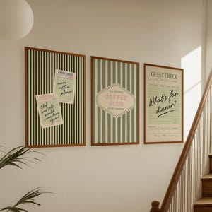 May include: Three framed wall art pieces with brown wooden frames. The art features vertical stripes in green and white, and text that reads "Guest Check", "Coffee Club", and "What's for dinner?"