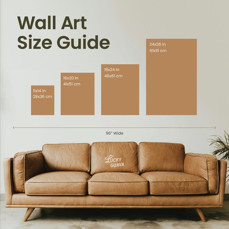 May include: Wall art size guide with dimensions in inches and centimeters. Includes sizes 11x14 in (28x36 cm), 16x20 in (41x51 cm), 18x24 in (46x61 cm), and 24x36 in (61x91 cm). A brown leather sofa is below the guide, with the text "Lucky Guava".