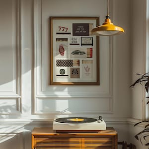 May include: A framed collage featuring various vintage-style images and text, including "777", "The End", and "Lucky You". A record player sits on a wooden cabinet below the artwork. A yellow pendant light hangs from the ceiling.