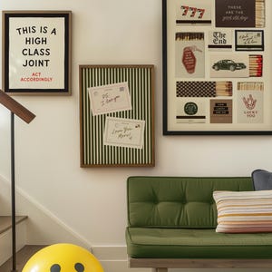 May include: A wall display featuring a framed print with the text THIS IS A HIGH CLASS JOINT ACT ACCORDINGLY, a green striped bulletin board with two notes, and a framed collage of matchbook designs. Below is a green tufted bench and a yellow smiley face ball.