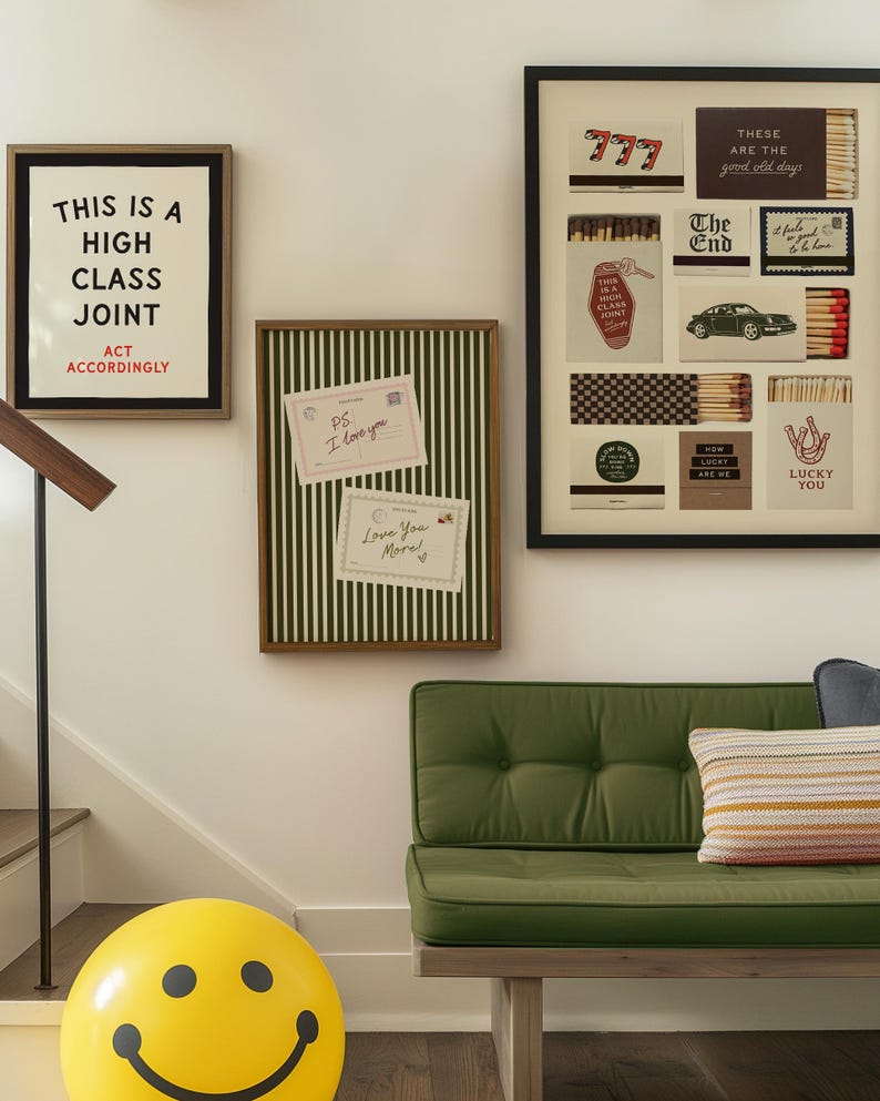 May include: A wall display featuring a framed print with the text THIS IS A HIGH CLASS JOINT ACT ACCORDINGLY, a green striped bulletin board with two notes, and a framed collage of matchbook designs. Below is a green tufted bench and a yellow smiley face ball.