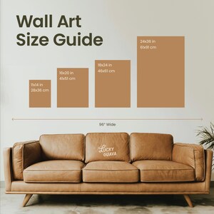 May include: Wall art size guide with dimensions in inches and centimeters. Includes sizes 11x14 in (28x36 cm), 16x20 in (41x51 cm), 18x24 in (46x61 cm), and 24x36 in (61x91 cm). A brown leather sofa is below the guide, with the text "Lucky Guava".