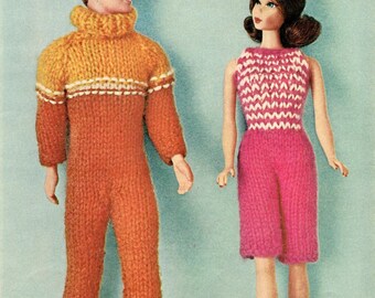 May include: Two vintage dolls, a male and female, are dressed in knitted outfits. The male doll wears an orange and yellow jumpsuit with a turtleneck. The female doll is in a pink knitted top and shorts. The background is a light blue.