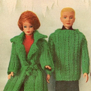 May include: A green knitted coat with a belt and a green knitted sweater. The coat is worn by a doll with red hair and a red dress. The sweater is worn by a doll with blond hair.