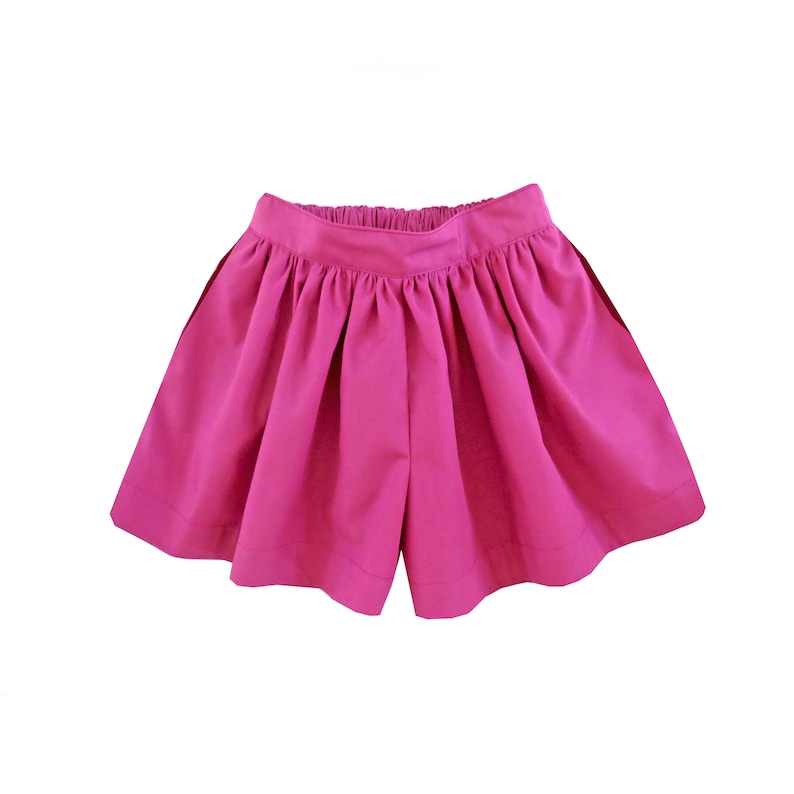 May include: A pair of pink shorts with a gathered waistband.
