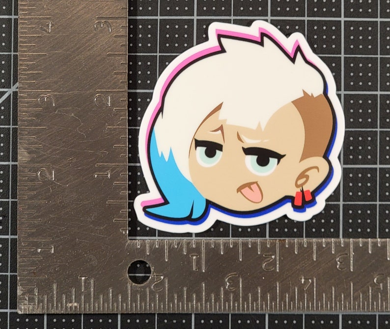 May include: A sticker of a cartoon character with white hair, blue eyes, and a tongue sticking out. The character is wearing red earrings and has a pink and blue outline.