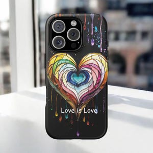 May include: A black phone case with a colorful stained glass heart design and the text "Love is Love".