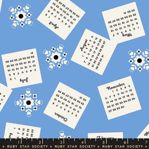 May include: A blue fabric featuring a repeating pattern of cream calendars and white floral designs. The calendars show months such as April, August, and November. The text "RUBY STAR SOCIETY" is at the bottom.
