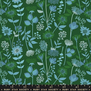 May include: A green fabric with a repeating pattern of blue stylized flowers and leaves. The fabric has a ruler with markings in inches and the text "RUBY STAR SOCIETY" repeated.