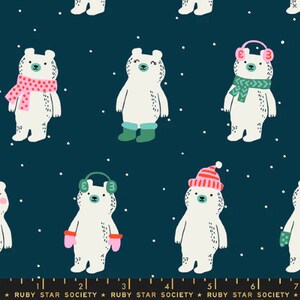 May include: A repeating pattern of white polar bears on a dark blue background. The bears are wearing winter accessories like scarves, earmuffs, hats, and boots. White dots, resembling snowflakes, are scattered throughout the design. The text "RUBY STAR SOCIETY" is at the bottom.