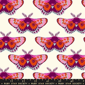 May include: A repeating pattern of colourful moths on a cream background. The moths have pink, orange, and blue details with dark purple bodies and antennae. The text "RUBY STAR SOCIETY" is printed at the bottom.