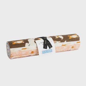May include: Rolled fabric with a repeating pattern of cartoon dogs in brown, white, and orange. The fabric is tied with a black ribbon and a tag that reads "DOG PARK". The fabric is rolled up, showing the edges of the fabric.