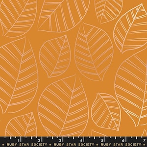 May include: A mustard yellow fabric featuring a repeating pattern of white line-drawn leaves. A black ruler at the bottom edge shows measurements from 1 to 7 inches, with the text RUBY STAR SOCIETY printed repeatedly along the black border.