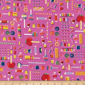 May include: Pink fabric with a repeating pattern of colorful candy, lollipops, and other sweets. The fabric is perfect for crafting projects, quilting, and sewing.