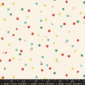 May include: Off-white fabric featuring a random pattern of colourful confetti dots in red, green, yellow, teal, and pink. The dots vary in size and shape, some are crescent-shaped. The bottom of the image has text that reads "RUBY STAR SOCIETY".