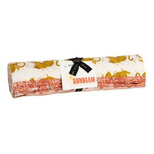 May include: A rolled bundle of fabric strips featuring a cream background with mustard yellow tiger illustrations and a secondary layer of terracotta fabric with white line patterns. A white paper tag reads SUNBEAM and RUBY STAR SOCIETY.