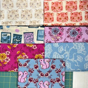 May include: A collection of patterned fabrics featuring various designs. The fabrics include cat faces, floral patterns, squirrels, and tea-themed illustrations. Colors include pink, blue, yellow, and cream.
