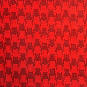 May include: Red fabric with a repeating pattern of dark red cat silhouettes. The fabric has the text "Patt. # 8585 - © Yolanda Fundora for Blank Quilting Corp 2016-KITTY".