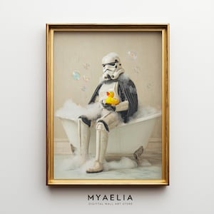 May include: A framed wall art print featuring a white and black armored character sitting in a white clawfoot bathtub filled with soap bubbles. The character holds a small yellow rubber duck, and floating bubbles surround the scene.