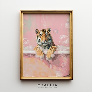 May include: A framed art print depicting a tiger in a bubble bath. The tiger, with orange and black stripes, is in a pink bathtub with bubbles. The frame is gold, and the text "MYAELIA" is at the bottom of the print.