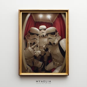 May include: A framed wall art print featuring three white stormtrooper helmets and armor in a red-curtained booth, captured with a fisheye lens effect. Below the frame, the text reads MYAELIA DIGITTAL WALL ART STORE.