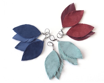 Suede feather earrings in blue, smoky blue and red wine.