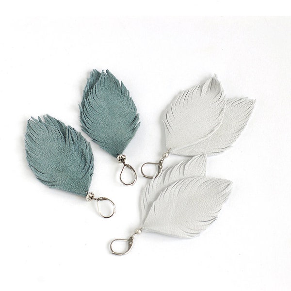 Suede leather feather earrings in smoky blue and in light grey. Set of two
