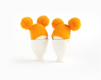Sunny yellow egg warmers with funny pompoms Easter decoration or small gift.