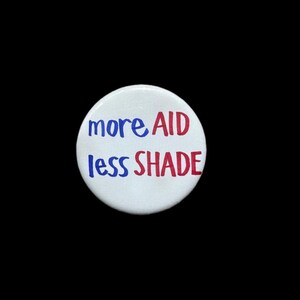 More Aid Less Shade Pinback Button: Global Health Advocacy