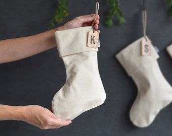 sustainable christmas stocking made of organic cotton personalized with a initial stamped birch bark tag christmas made by renna deluxe