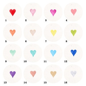 May include: A set of 16 round paper circles with different coloured hearts in the centre. The circles are numbered 1 through 16.