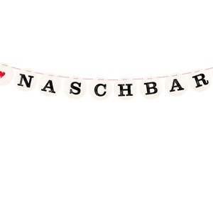 May include: A white banner with red hearts and the word "NACHBAR" in black letters.