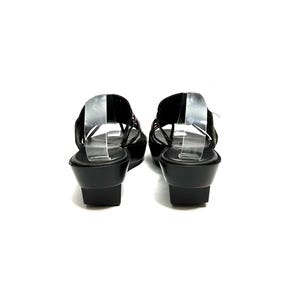 May include: A pair of black leather heeled sandals with a criss-cross strap design. The sandals have a slingback strap and a wedge heel.