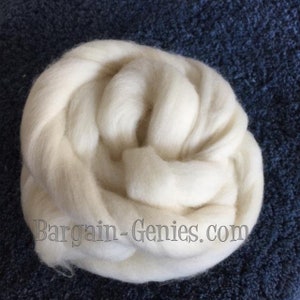 May include: A coiled bundle of off-white wool roving with a soft, fibrous texture. The text Bargain-Genies.com is printed in a dark, stylized font across the lower portion of the white wool fibers, which are arranged in a circular pattern.