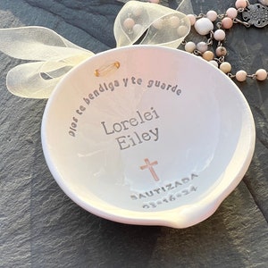 clarey clayworks baptism bowl for girls in spanish shown with pink rosary on slate background