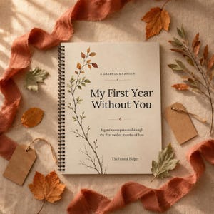 May include: A spiral-bound journal with a cream cover featuring a botanical illustration of a branch with autumn-colored leaves. The text reads: A GRIEF COMPANION, My First Year Without You, A gentle companion through the first twelve months of loss, The Funeral Helper.