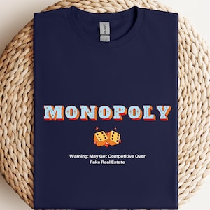 Camiseta de Monopoly. Advertencia: ¡Puede generar competencia por bienes raíces falsos! Prenda divertida de juego de mesa. Regalo para fanáticos del Monopoly. Disponible en tallas S a 3XL.