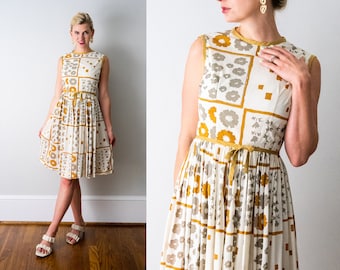 vintage 1960's gold floral print dress. 60 ivory and yellow dress. pleated skirt. sleeveless. flowers. bow. xs.