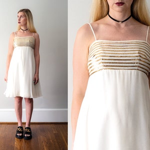 1960's white babydoll dress. vintage 60 chiffon mini dress. white and gold sequins. sleeveless. empire waist. xs.